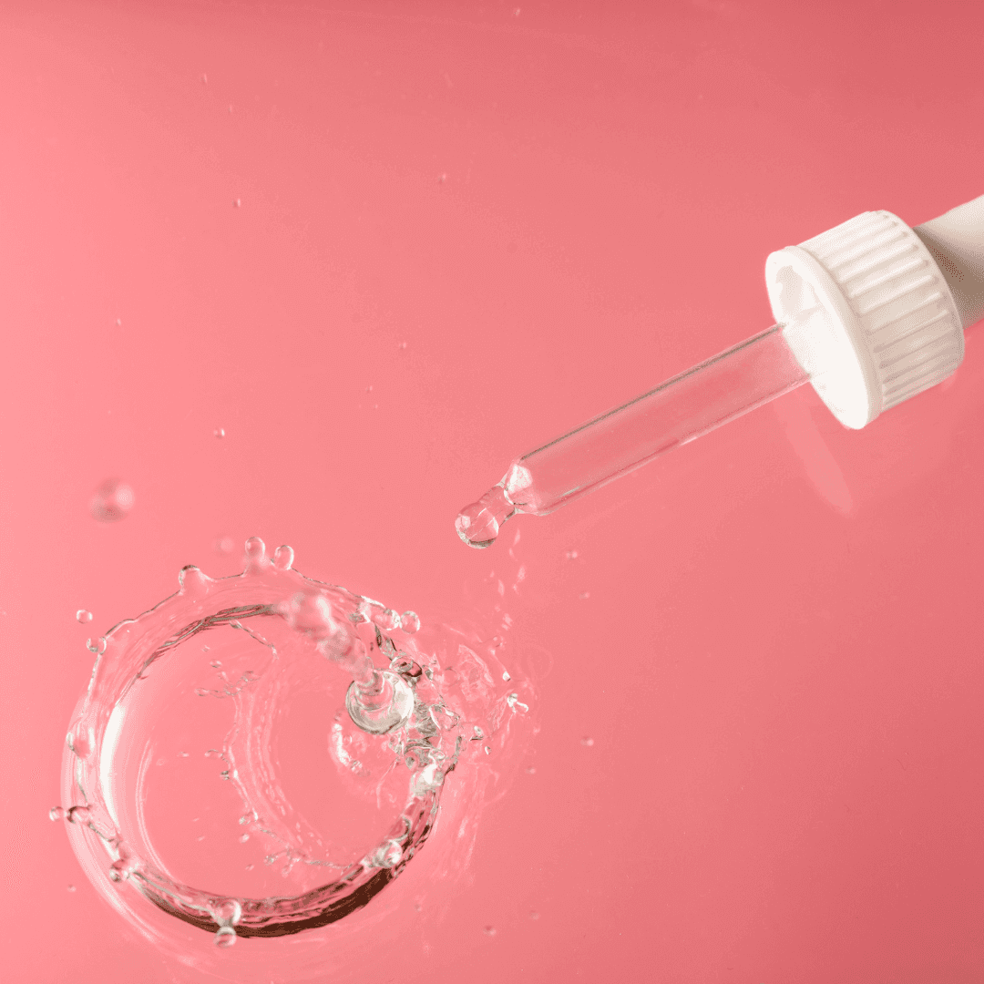 Goutte de sérum tombant dans l'eau, illustrant l'hydratation intense du Sérum hydratant, Hydralips 💋. Soin microneedling des lèvres pour une bouche repulpée.