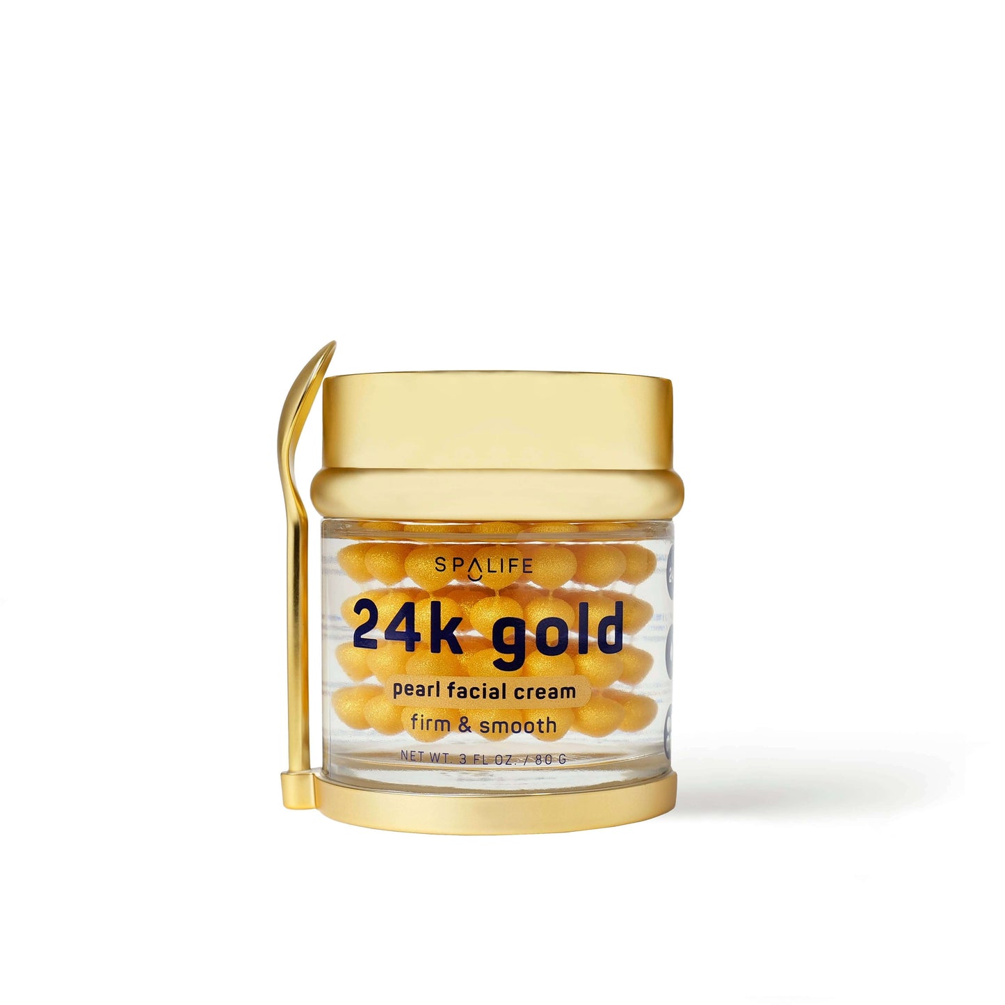 Crème raffermissante pour le visage aux perles en or 24 carats dans un pot transparent avec couvercle doré et spatule assortie. Soin luxueux pour une peau lisse et éclatante.