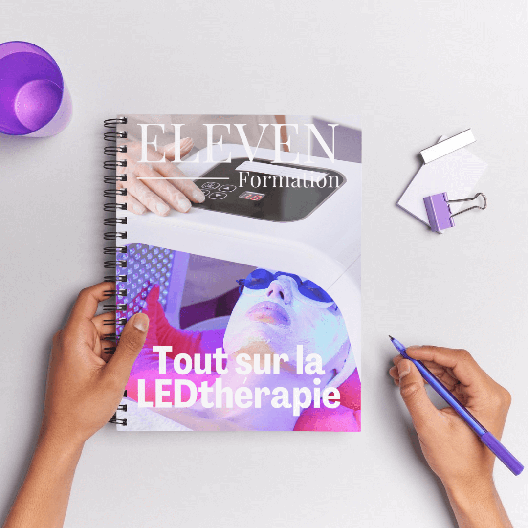 Carnet de formation 'Tout sur la LEDthérapie' avec une couverture illustrée, tenu par des mains, accompagné d'outils de bureau.